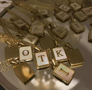 Pearl back initial necklaces