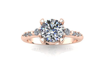 Three stone engagement ring with round center stone